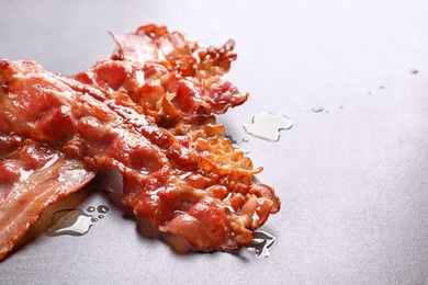 Photo of Fried bacon on grey background