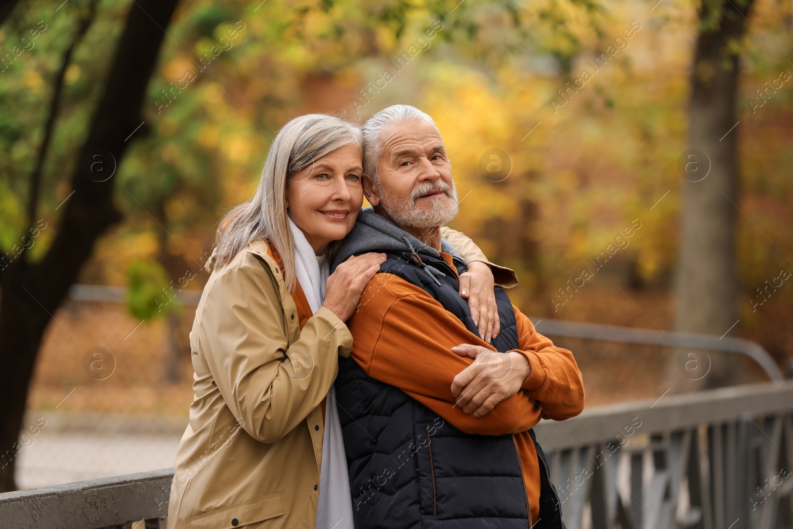 Photo of Portrait of affectionate senior couple in autumn park