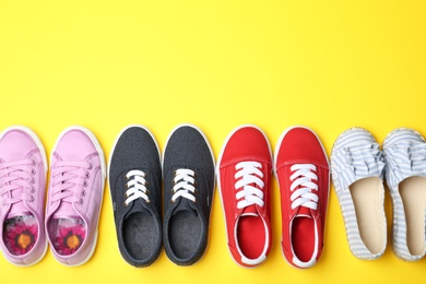 Photo of Flat lay composition with stylish new shoes on color background