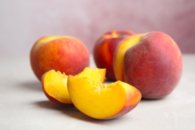 Cut and whole juicy peaches on light table