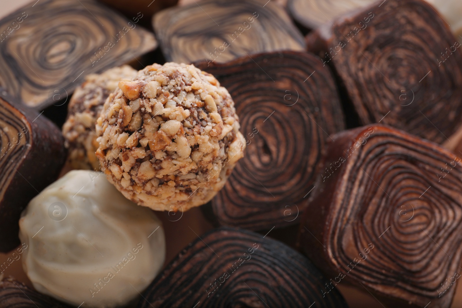 Photo of Different tasty chocolate candies as background, closeup