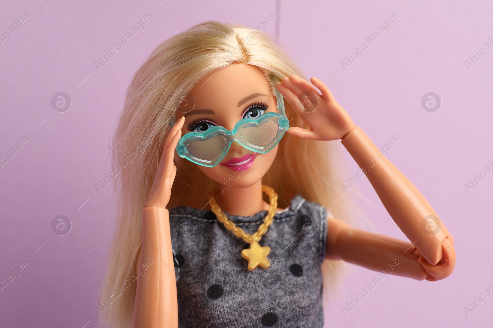 Photo of Mykolaiv, Ukraine - September 4, 2023: Beautiful Barbie doll with stylish eyeglasses on lilac background