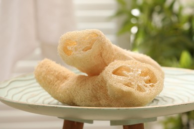 Photo of Loofah sponges on coffee table indoors, closeup