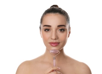 Photo of Woman using natural pink quartz face roller on white background