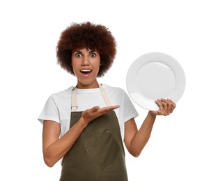 Emotional young woman in apron holding plate on white background