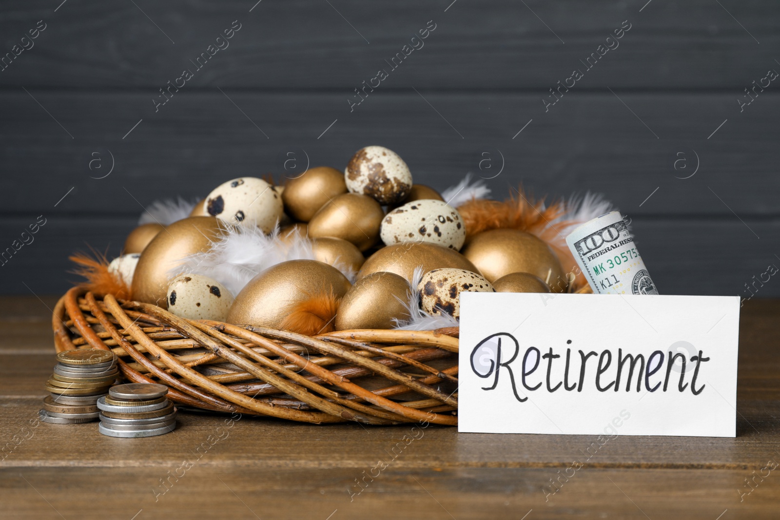 Photo of Many golden and quail eggs in nest, money near card with word Retirement on wooden table. Pension concept
