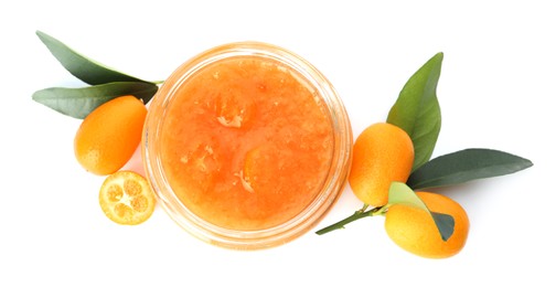 Jar of delicious kumquat jam, fresh fruits and leaves on white background, top view