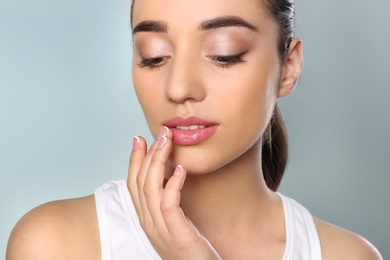 Photo of Young woman with sexy lips on color background