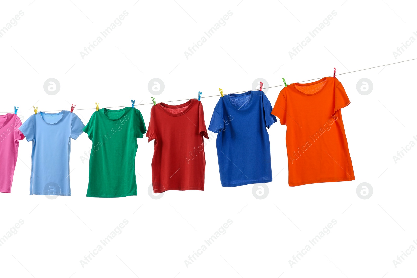 Photo of Colorful t-shirts drying on washing line isolated on white