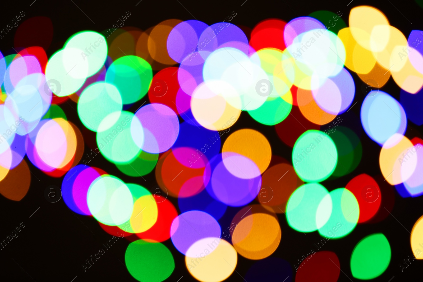 Photo of Beautiful colorful lights on dark background. Bokeh effect