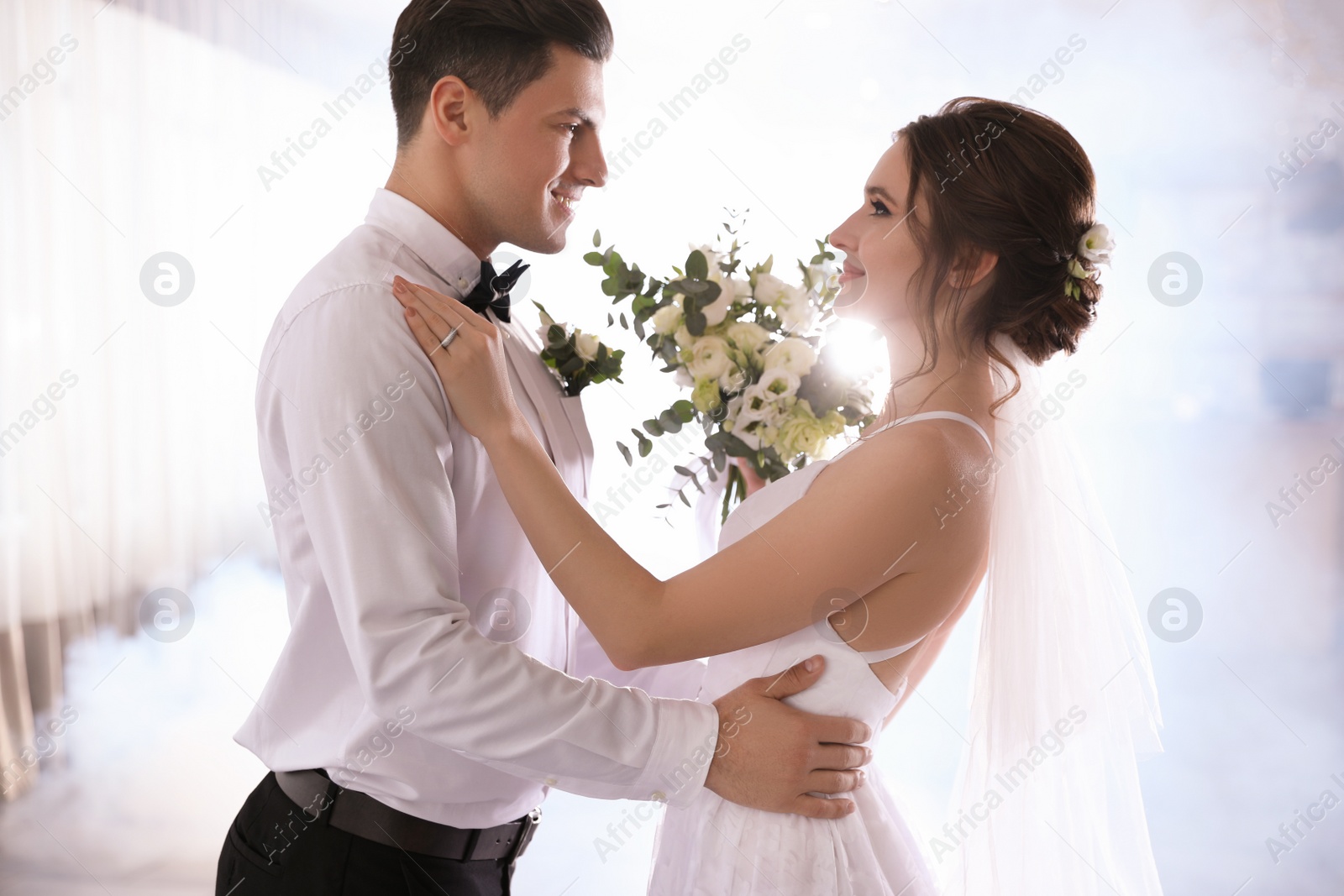 Photo of Happy newlywed couple dancing together in festive hall