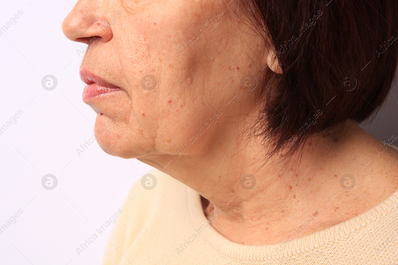 Photo of Closeup view of older woman on white background