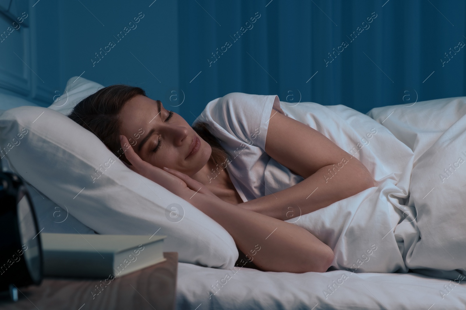 Photo of Beautiful woman sleeping in bed at night