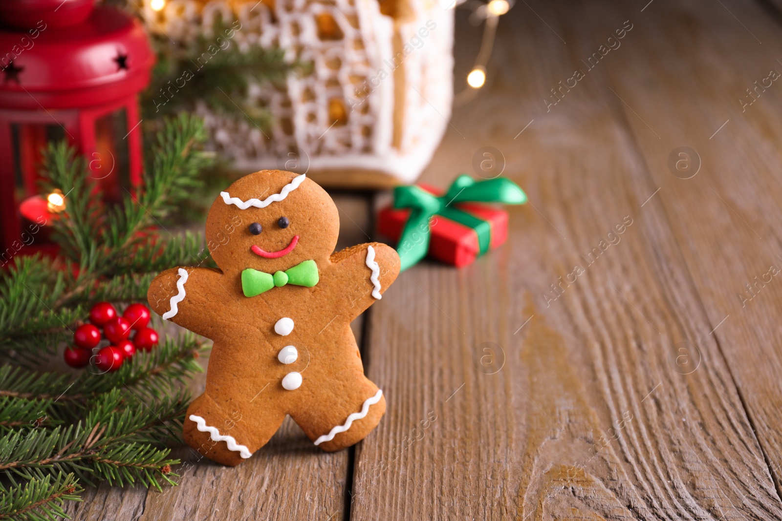 Photo of Gingerbread man on wooden table, space for text