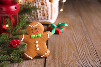 Gingerbread man on wooden table, space for text