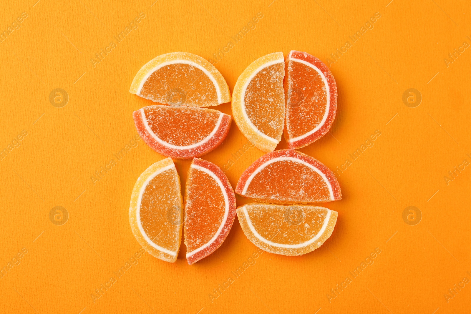 Photo of Flat lay composition with delicious jelly candies on color background