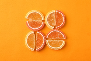 Photo of Flat lay composition with delicious jelly candies on color background