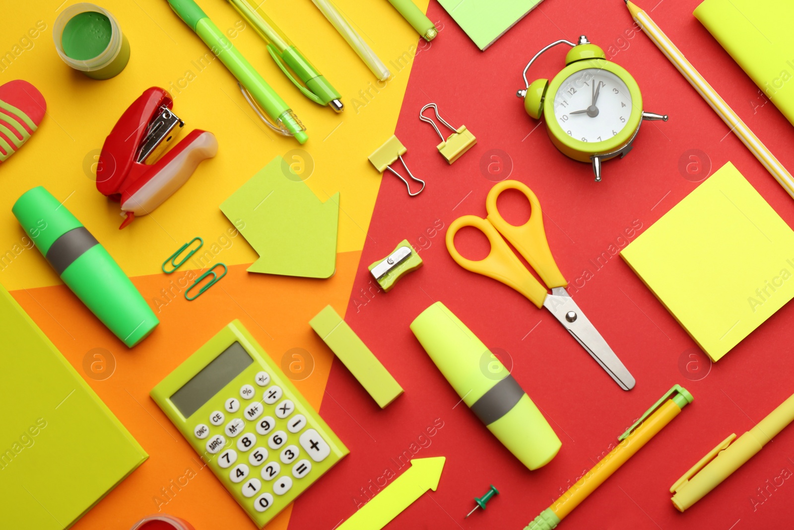 Photo of Different bright school stationery on color background, flat lay