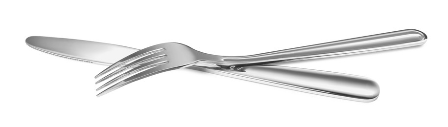 Photo of Fork and knife isolated on white. Stylish shiny cutlery set