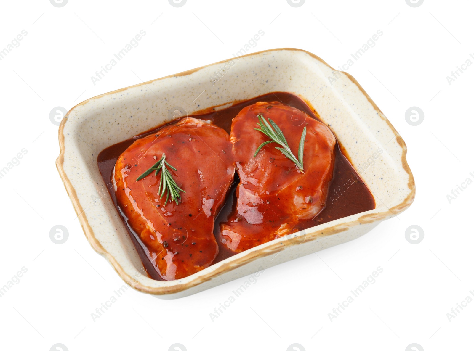 Photo of Raw marinated meat and rosemary in baking dish isolated on white