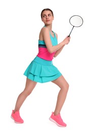 Young woman playing badminton with racket on white background