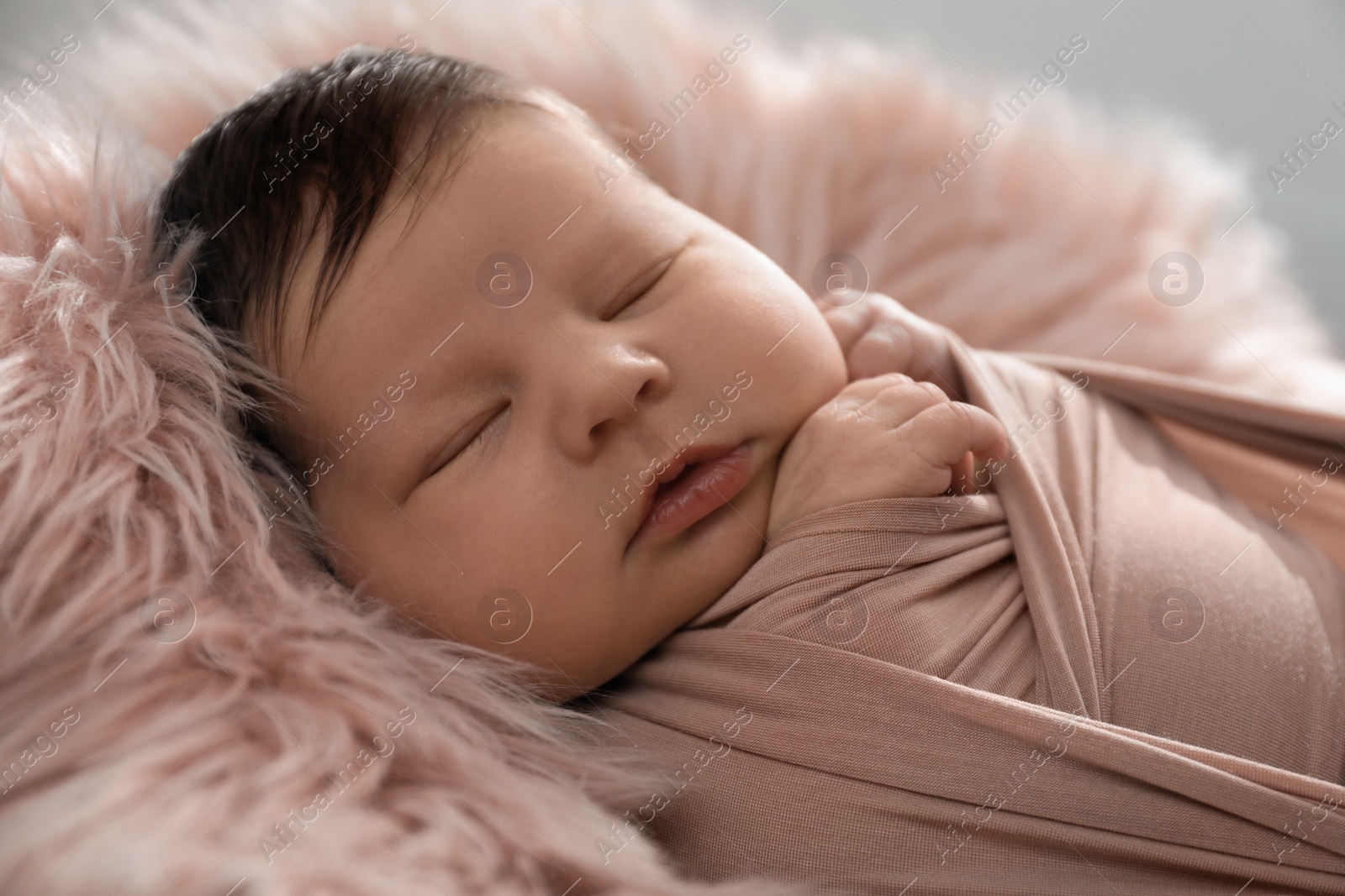 Photo of Cute newborn baby sleeping on fuzzy blanket, closeup