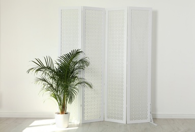 Photo of Modern folding screen in light spacious room