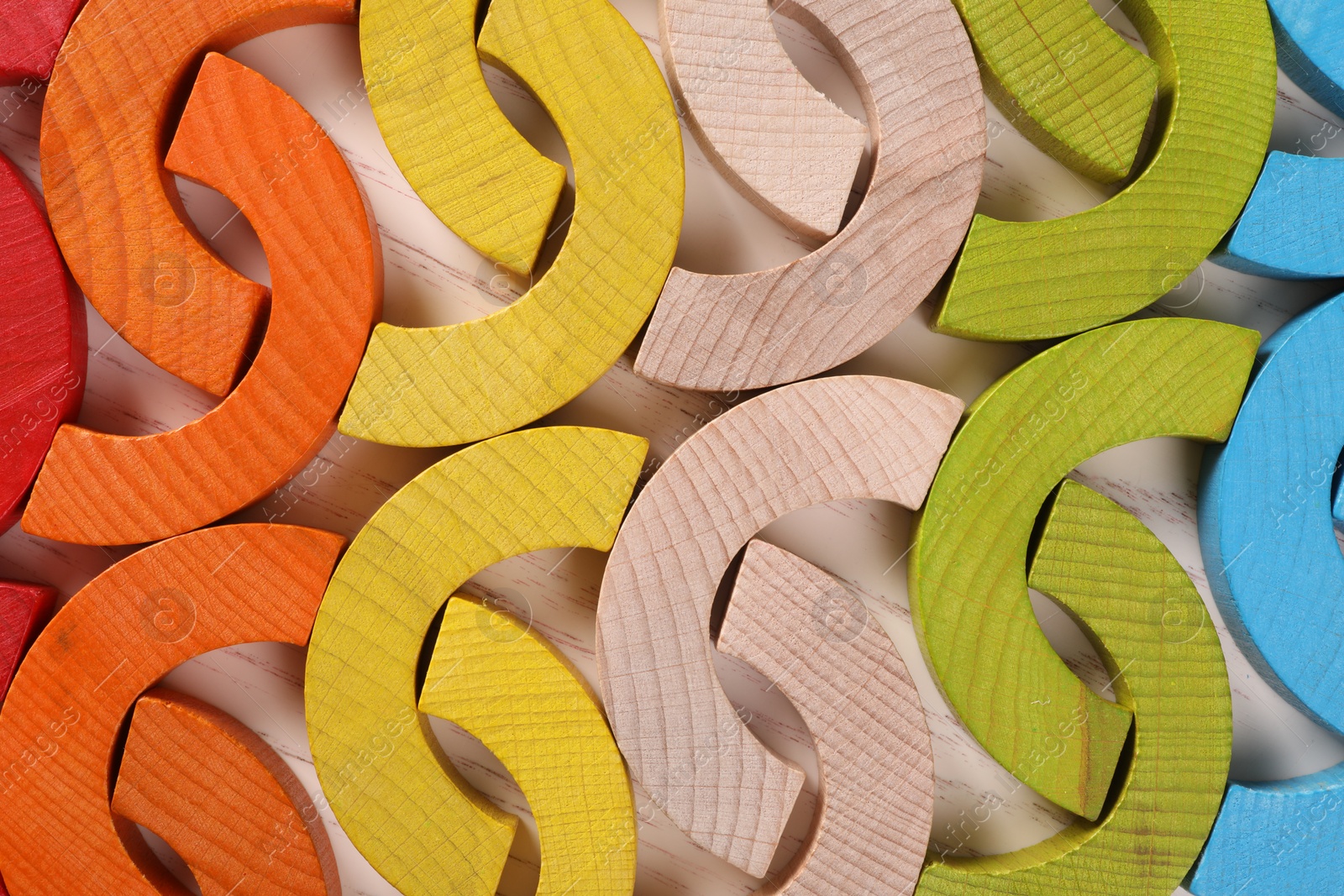 Photo of Colorful wooden pieces of playing set on white table, top view. Educational toy for motor skills development