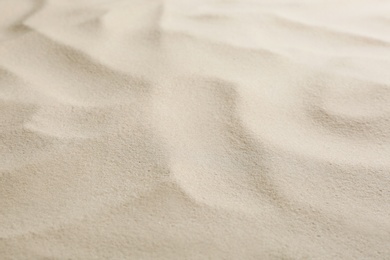 Photo of Dry beach sand as background, closeup view