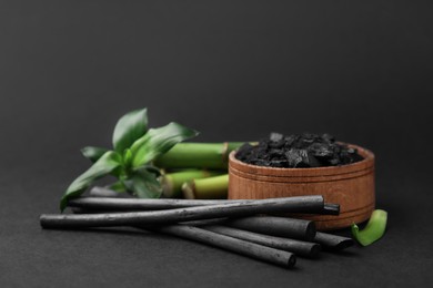 Fresh bamboo and charcoal on black background
