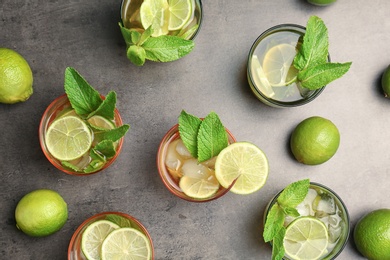 Photo of Flat lay composition with mint julep cocktail in glasses on grey background