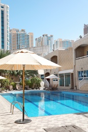 Photo of Modern luxury hotel with swimming pool on sunny day