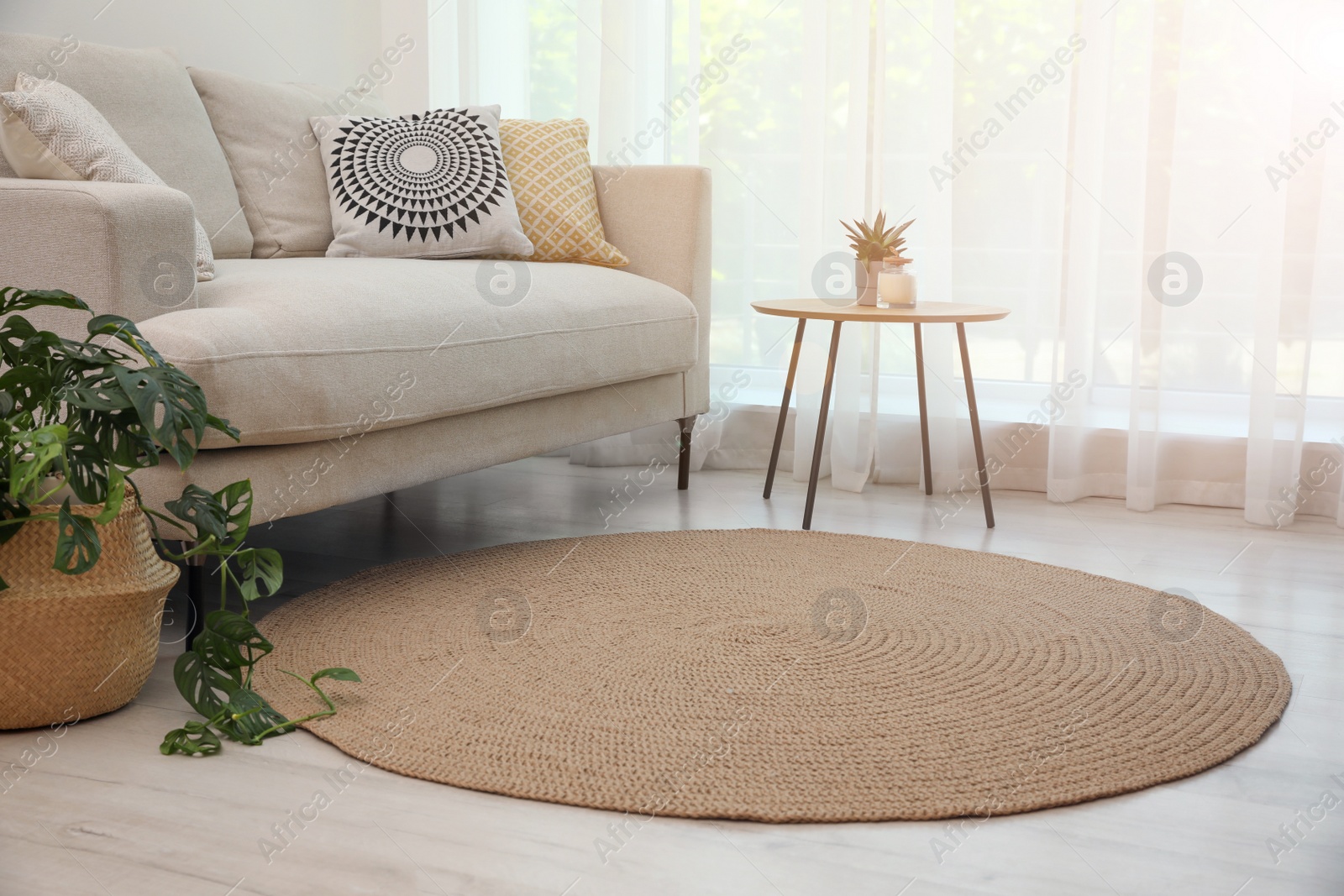 Photo of Living room interior with comfortable sofa and stylish round rug