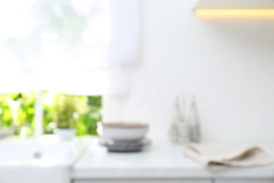 Photo of Blurred view of modern kitchen with window