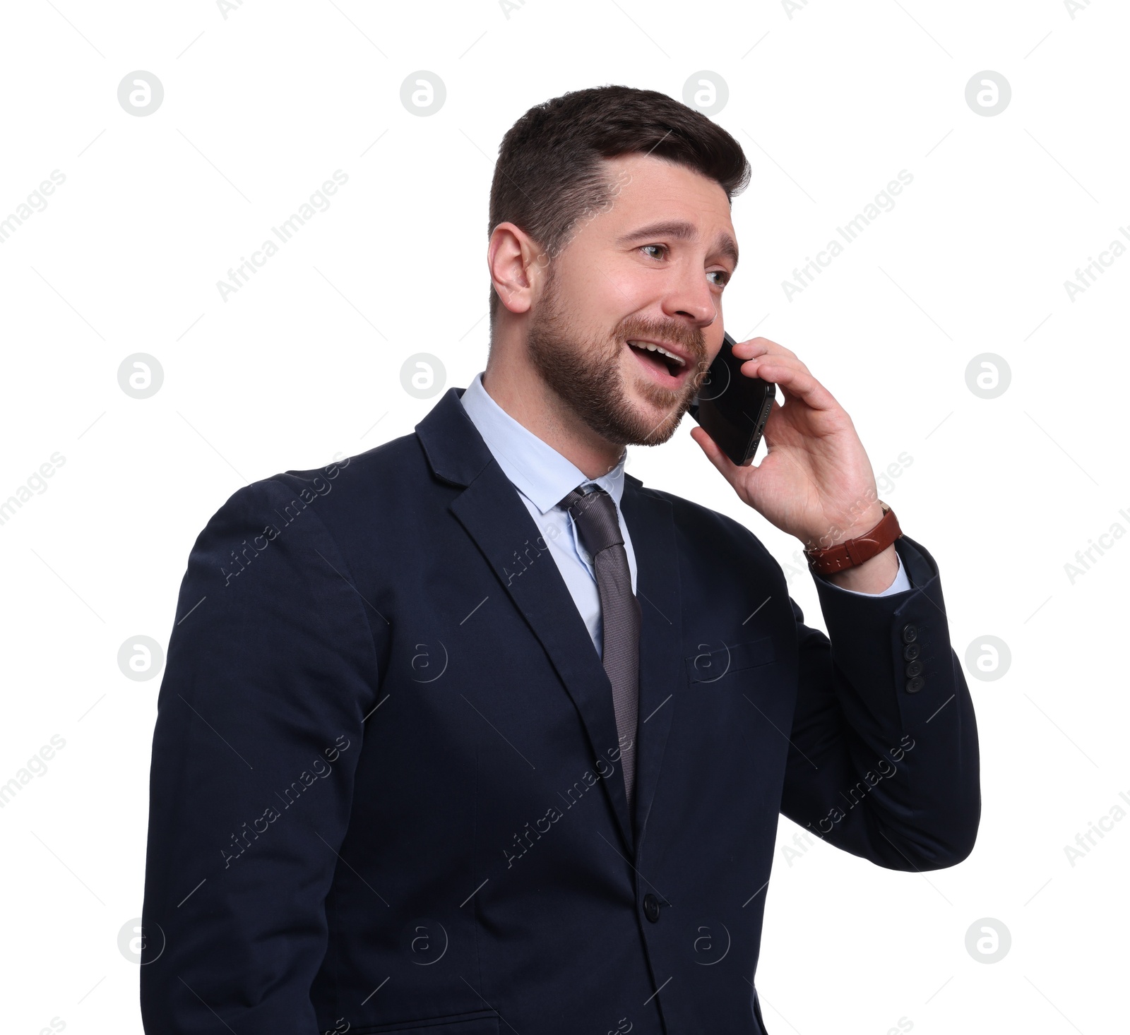 Photo of Handsome bearded businessman in suit talking on smartphone against white background