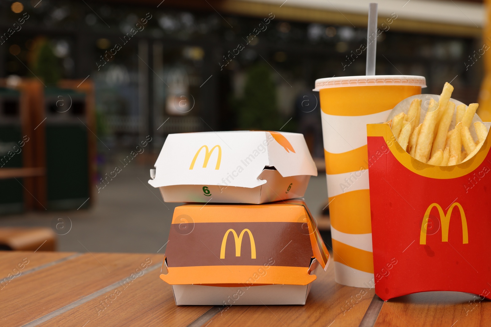 Photo of Lviv, Ukraine - October 9, 2023: McDonald's menu on wooden table outdoors, space for text