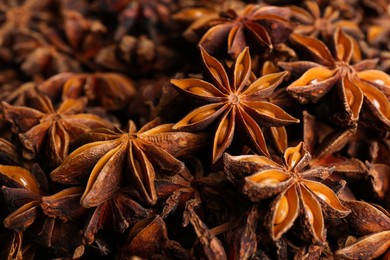 Photo of Aromatic anise stars as background, closeup view