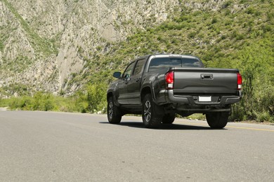 Black car on road near beautiful mountains outdoors