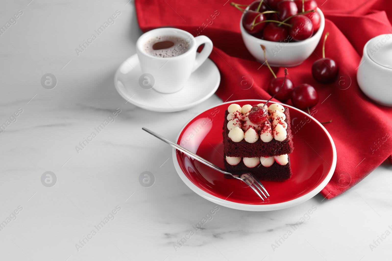 Photo of Piece of delicious red velvet cake served on white marble table, space for text