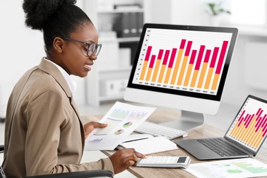 Photo of Professional accountant working at wooden desk in office