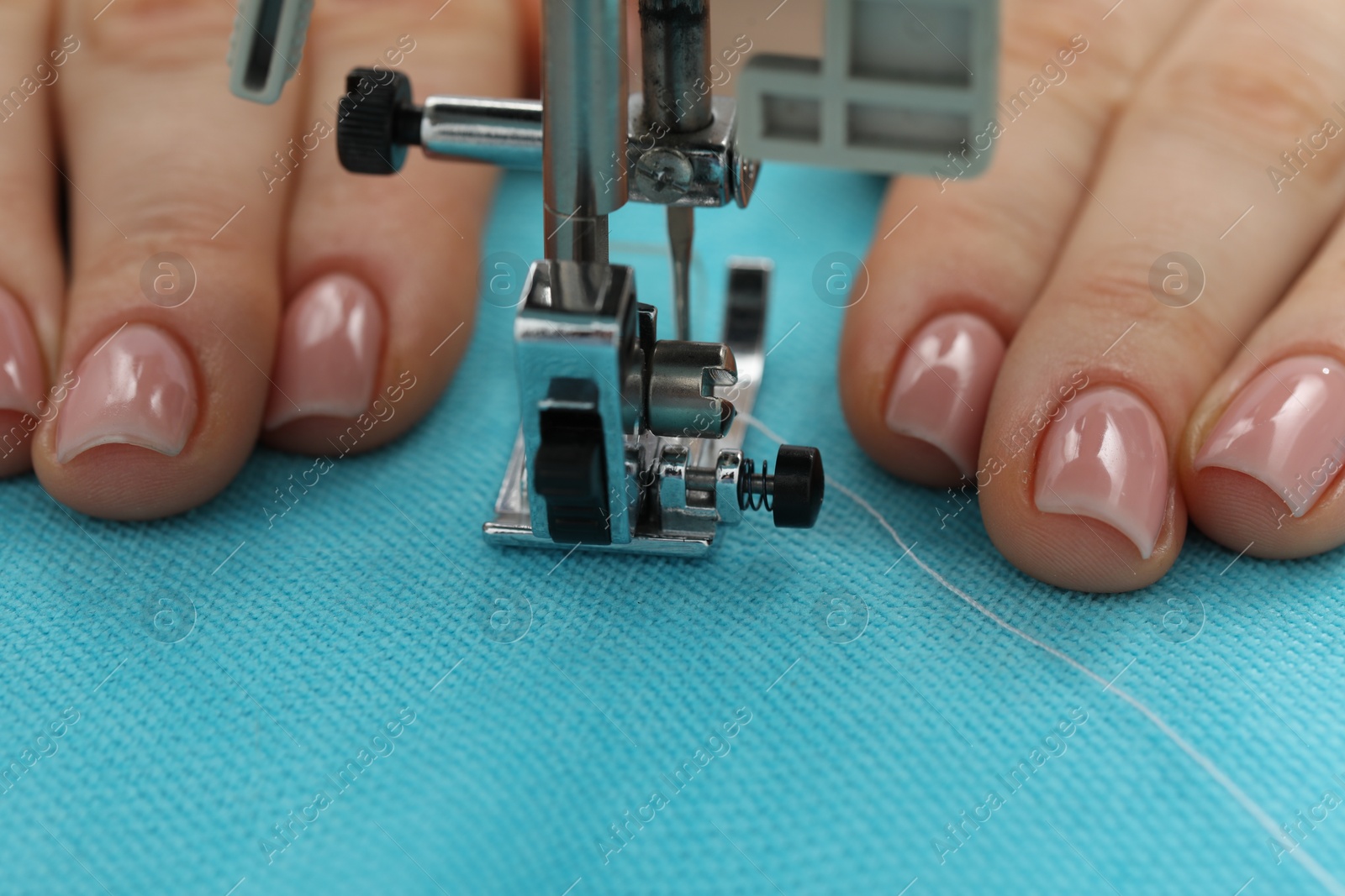 Photo of Seamstress working with sewing machine, selective focus