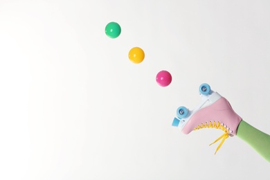 Photo of Woman with vintage roller skate and balls on white background, closeup. Space for text