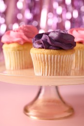 Photo of Delicious cupcakes with bright cream on pink background, closeup