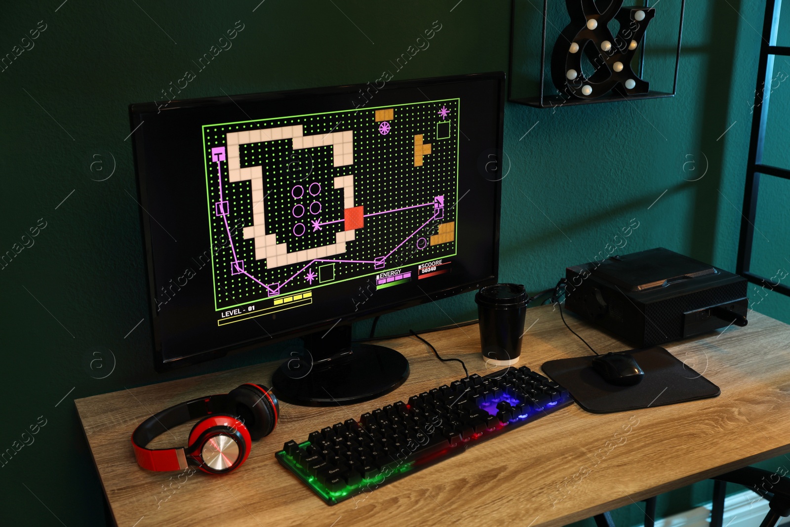 Photo of Modern computer, RGB keyboard and headphones on wooden table indoors