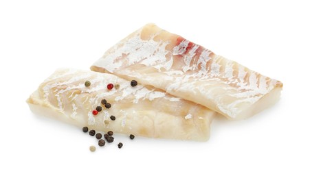 Fresh raw cod fillets with peppercorns isolated on white