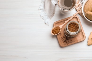 Photo of Flat lay composition with instant coffee on white wooden table. Space for text