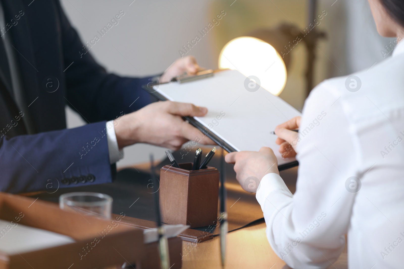 Photo of Male lawyer working with client in office, closeup