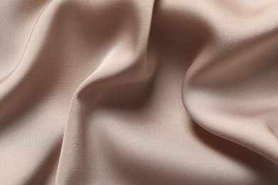 Texture of beige crumpled silk fabric as background, top view