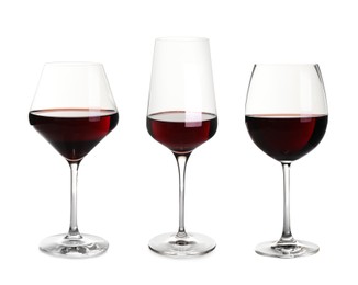 Image of Set with glasses of delicious expensive red wine on white background