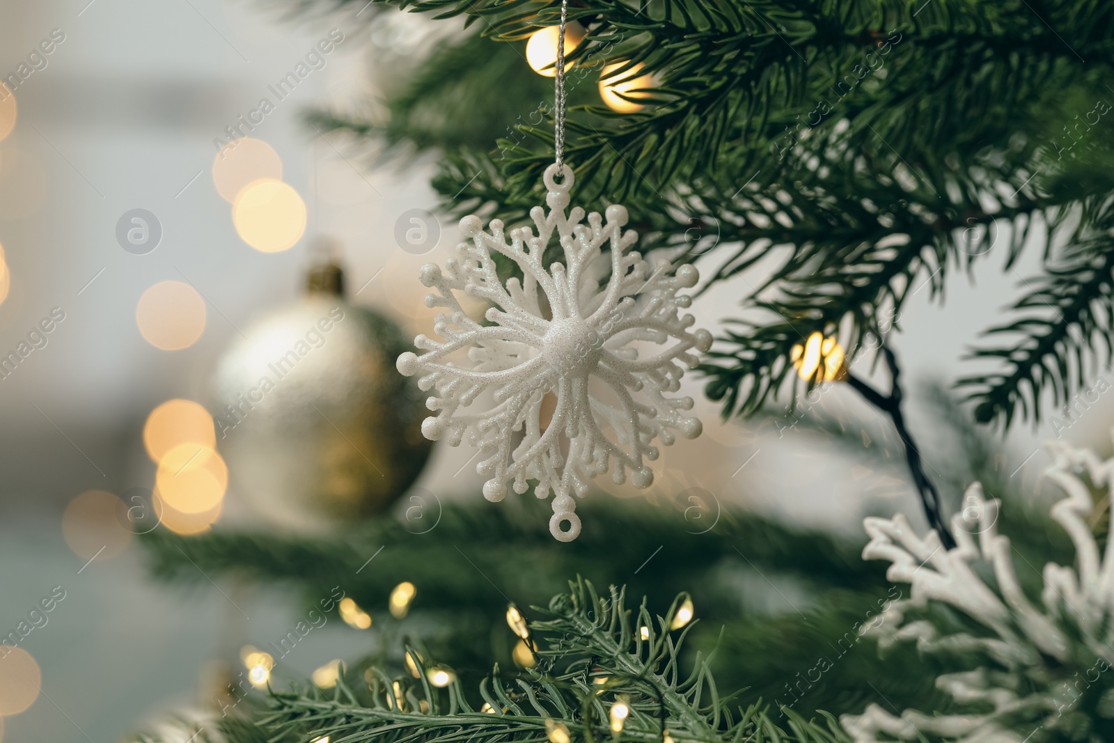 Photo of Closeup of beautiful bauble hanging on Christmas tree